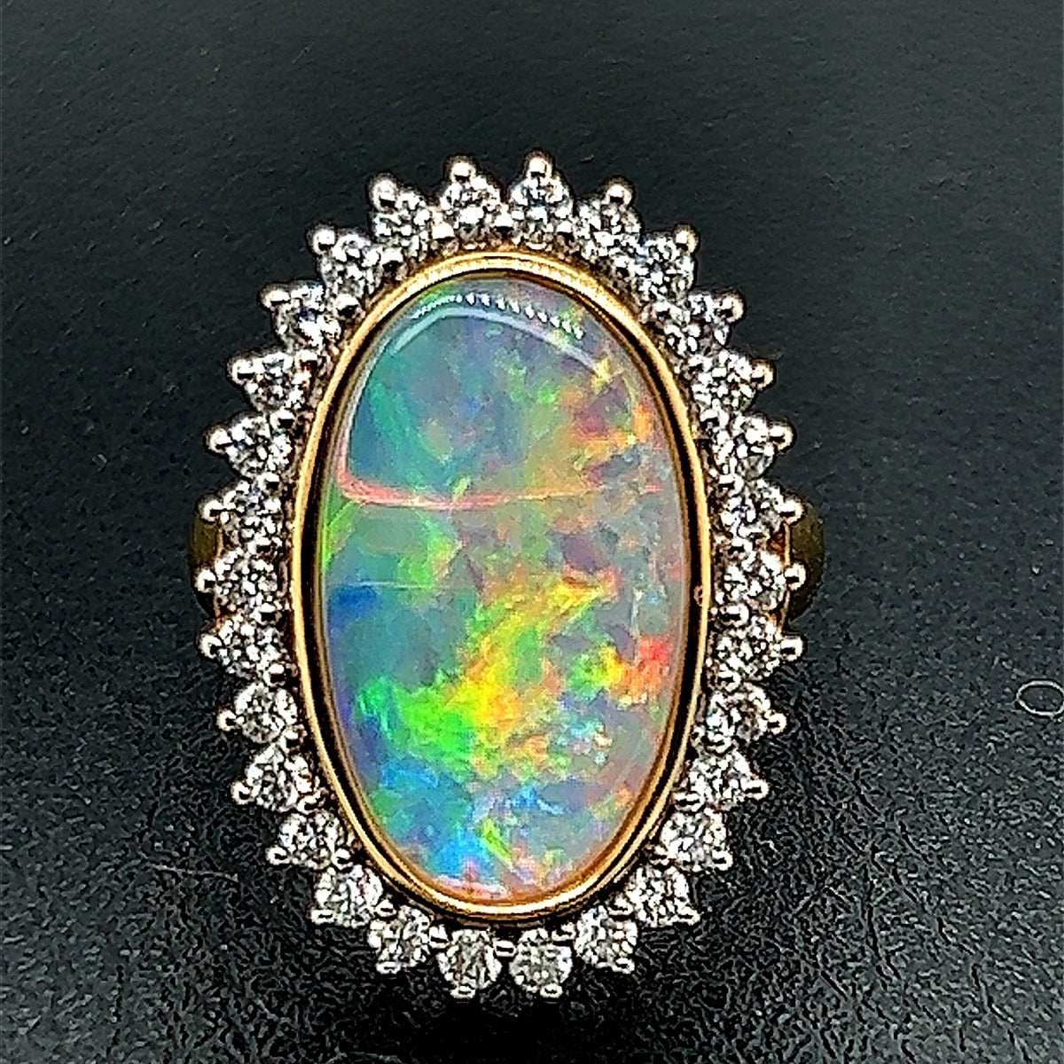 Solid Opal set in 18ct yellow gold ring surrounded by diamonds (sr541) Solid Opal set in 18ct yellow gold ring surrounded by diamonds (sr541)