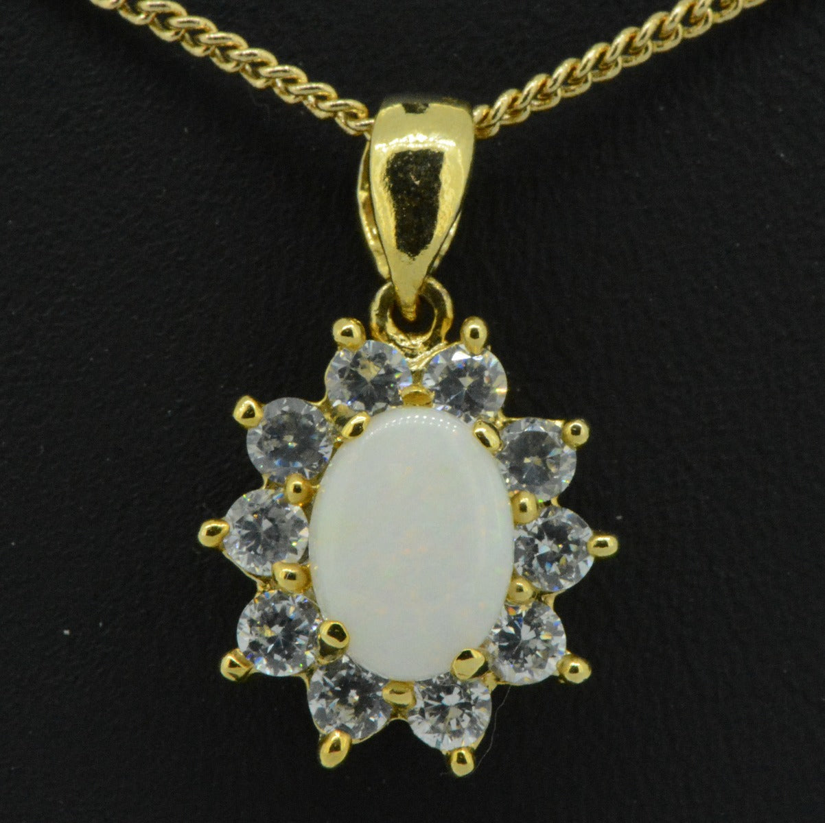 Gold plated solid opal pendant surrounded by cut crystrals (gpsp8131)